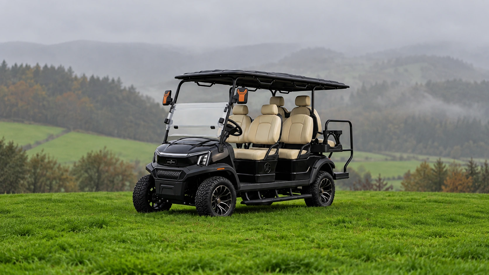 Black Cortéa electric golf cart with cream seating in a misty countryside landscape